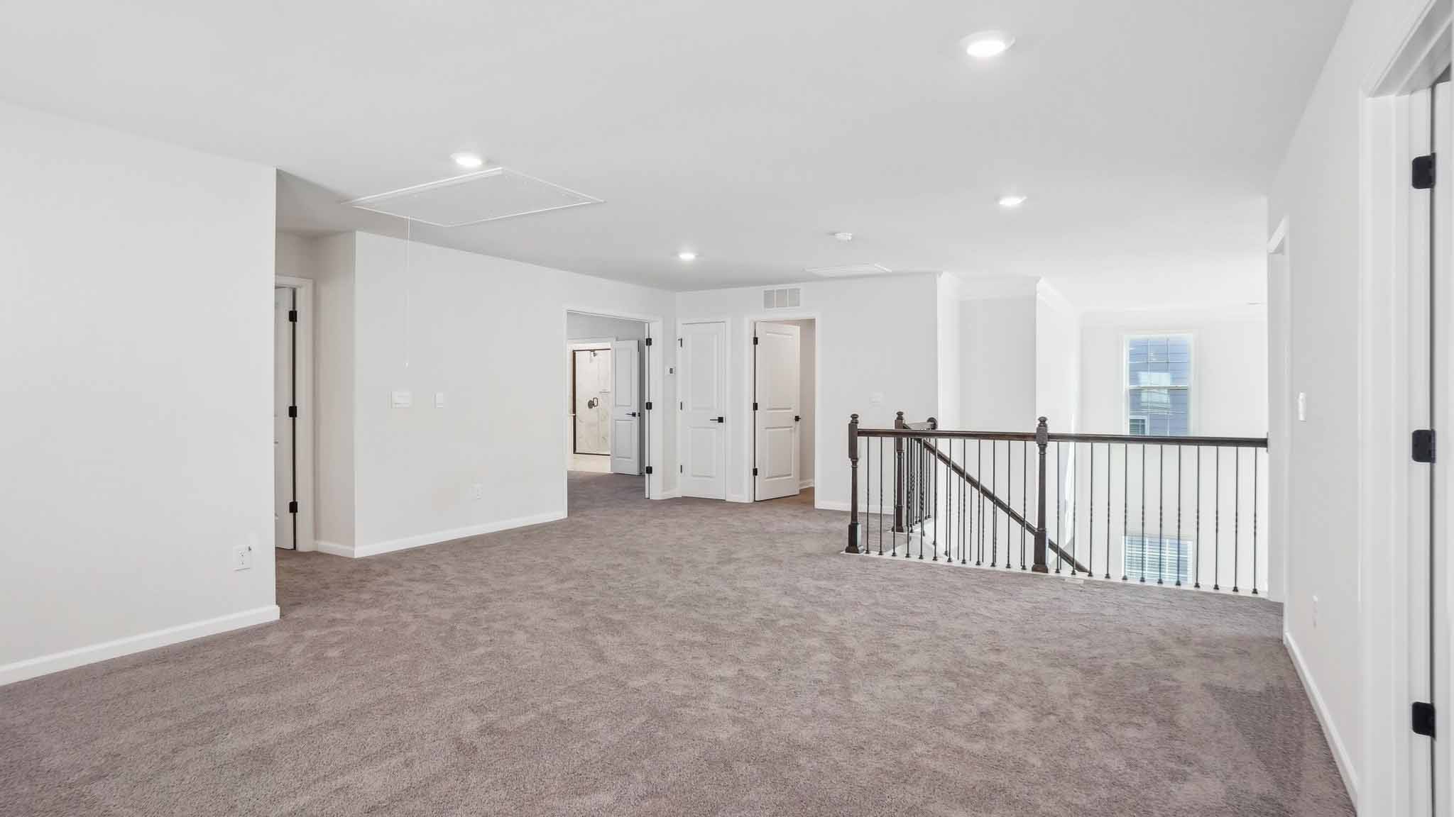 Carpeted bedroom with ceiling fan and small window