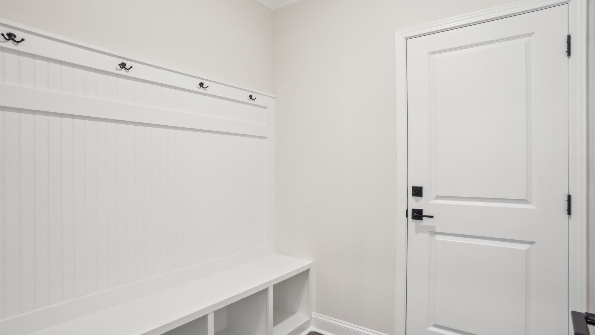 Laundry room with racks above the machines