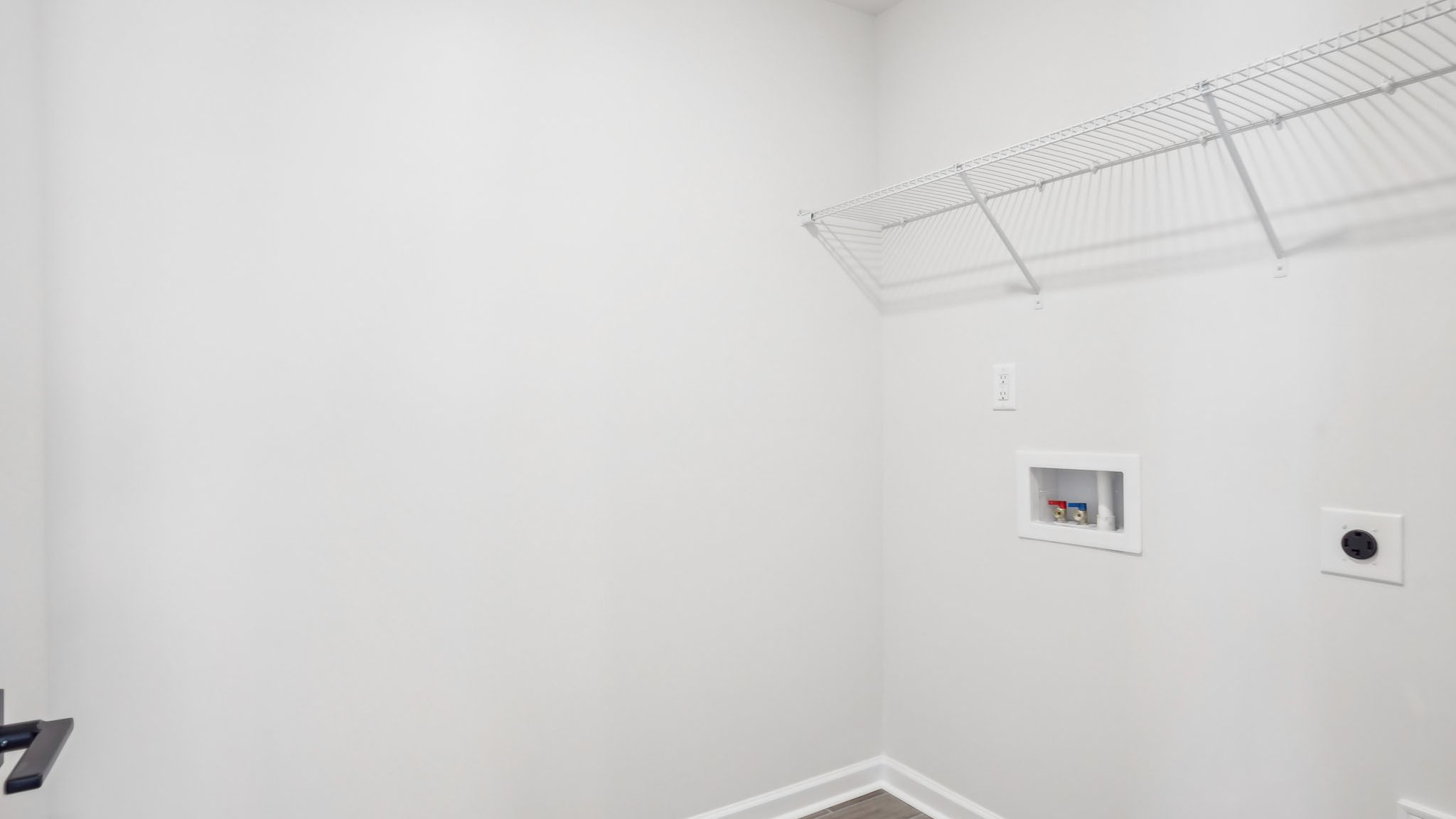 Laundry room with racks above the machines