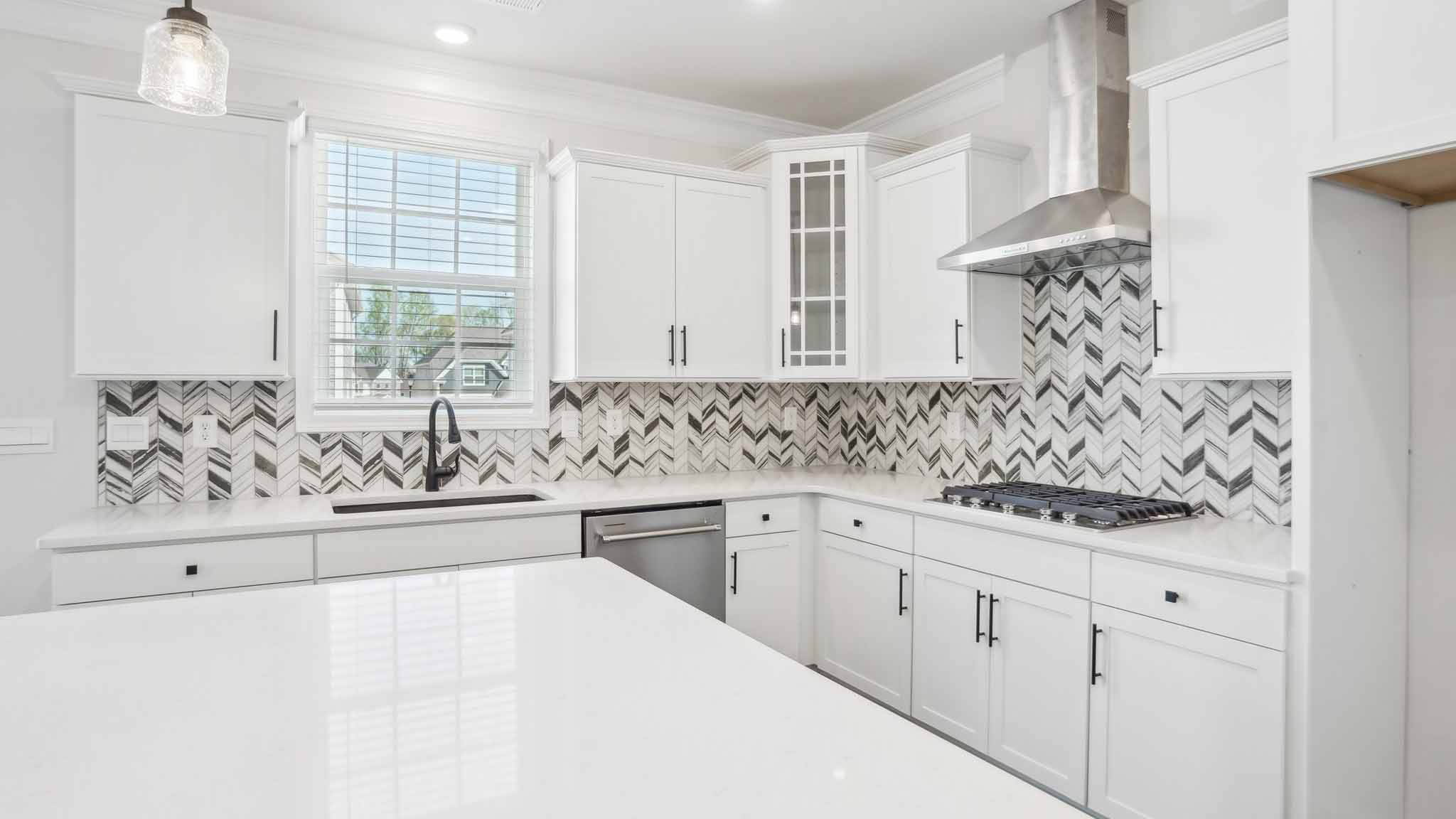 Kitchen and island with brown cabinets, and stainless steel appliances