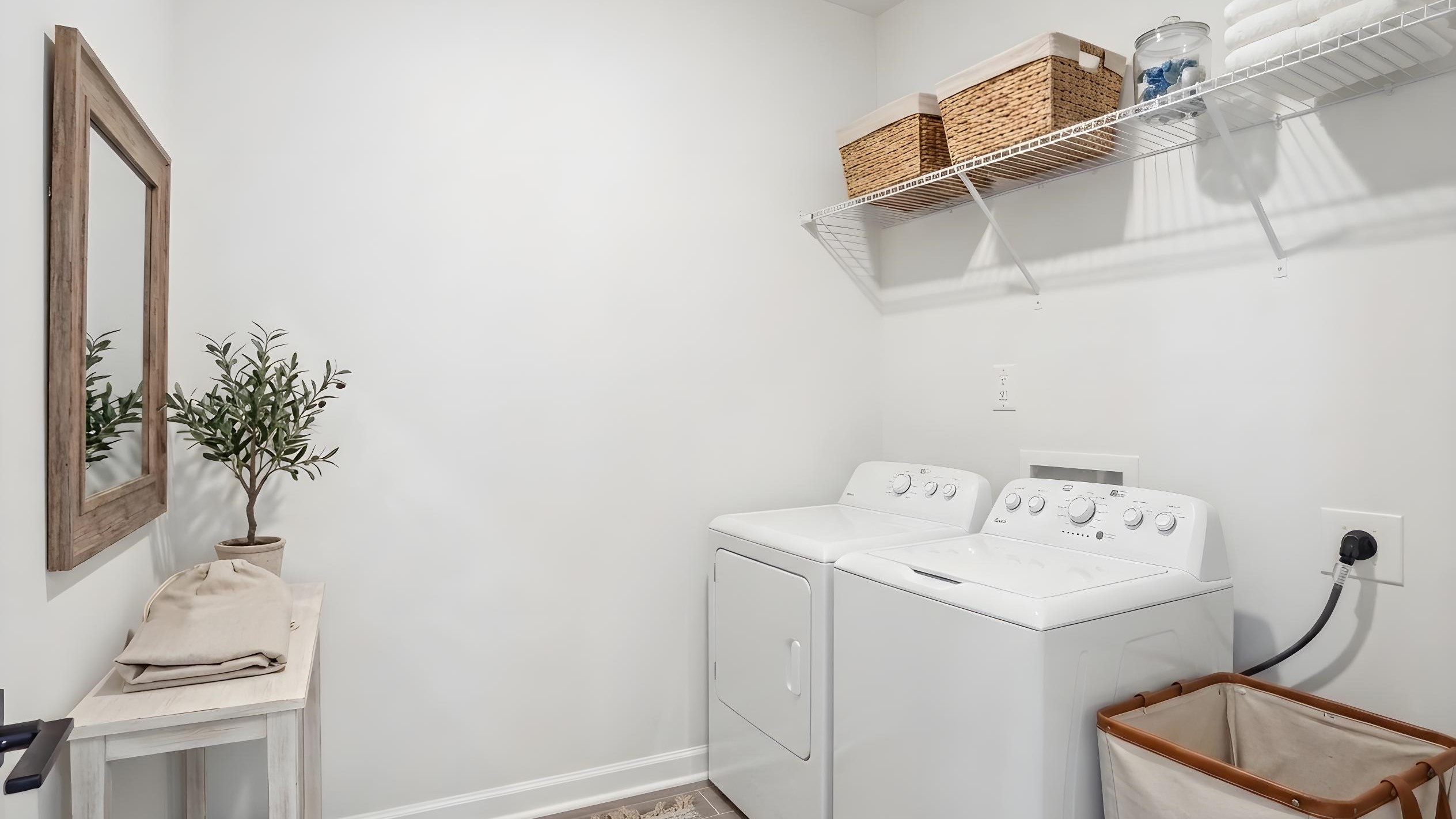 Laundry room with racks above the machines