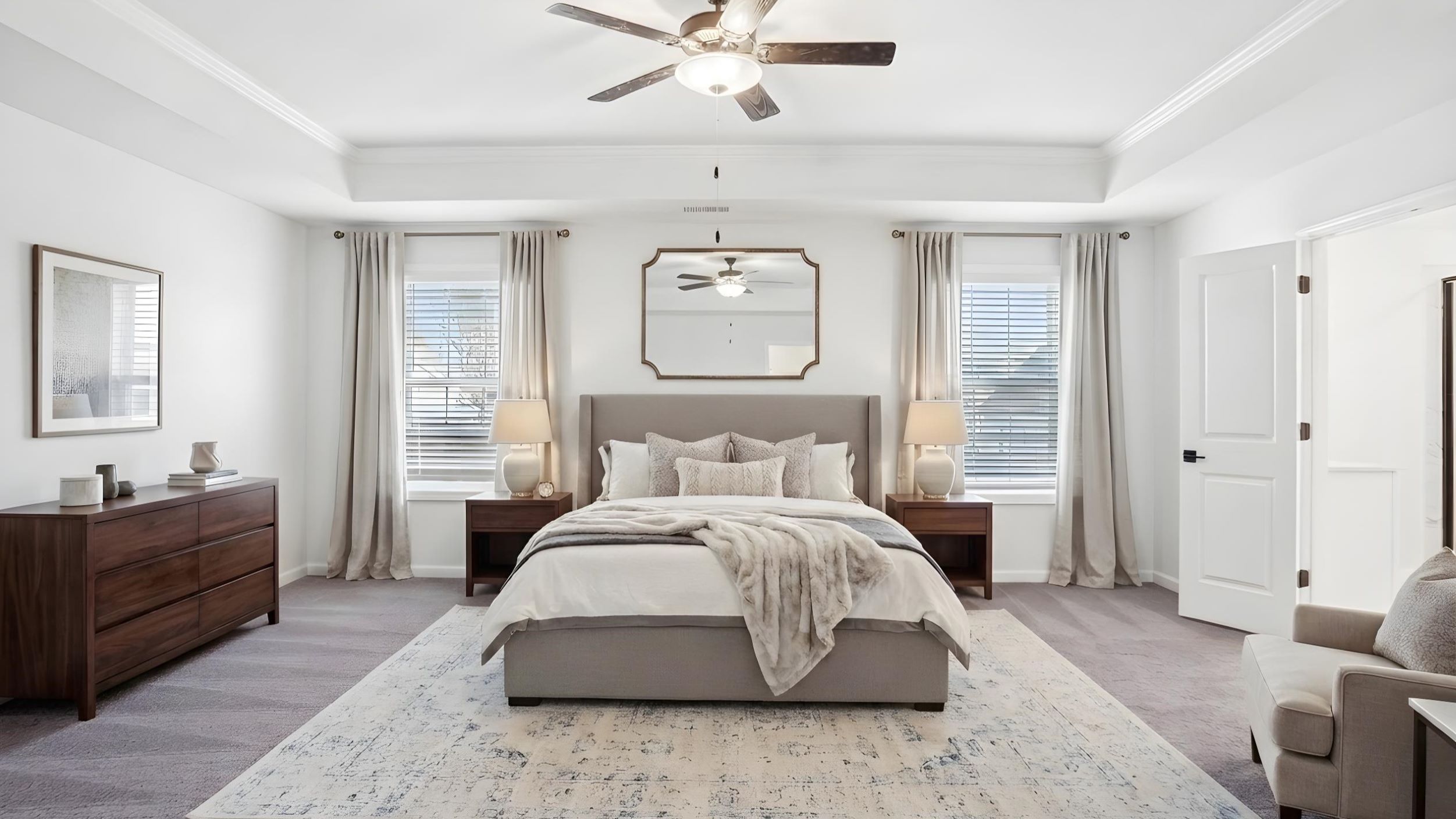 Carpeted bedroom with ceiling fan and small window