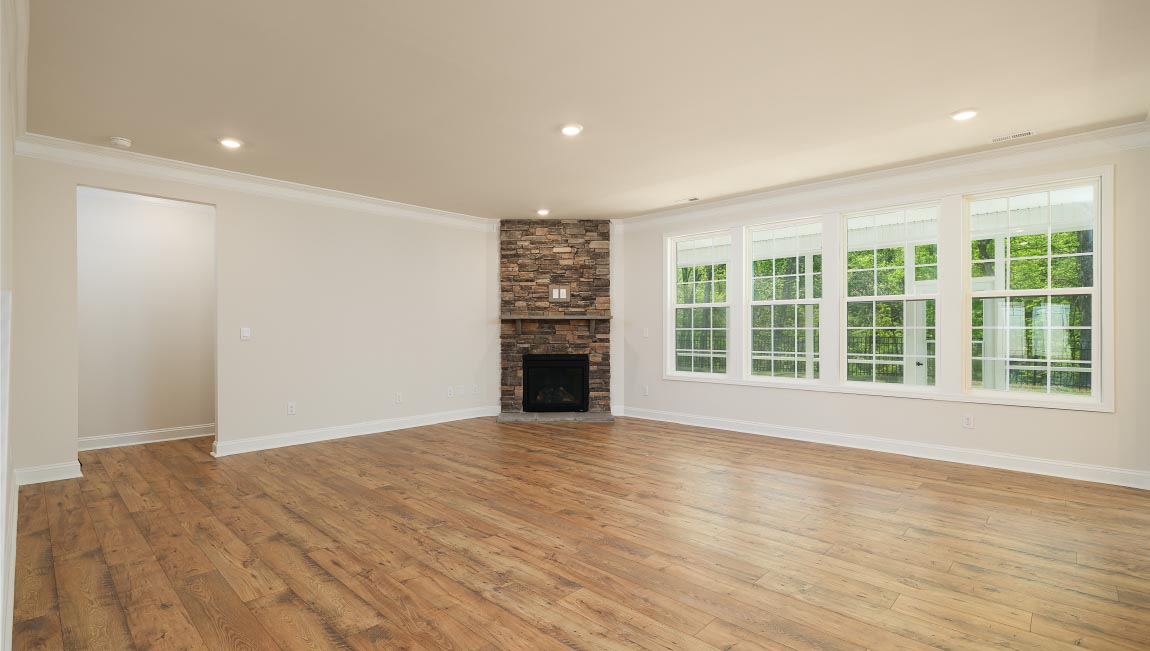 Open great room with large windows and fireplace