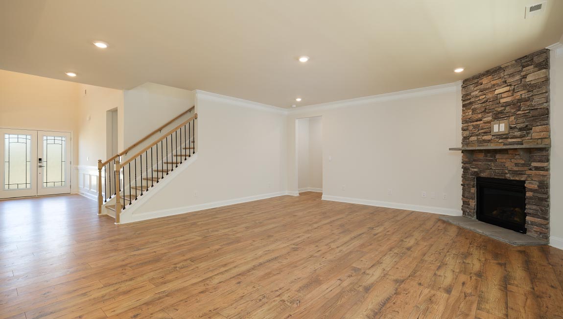 Open great room with large windows and fireplace