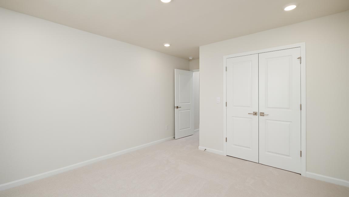 Carpeted bedroom with small window