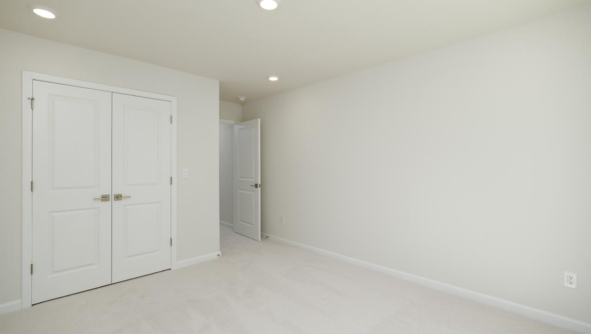 Carpeted bedroom with small window