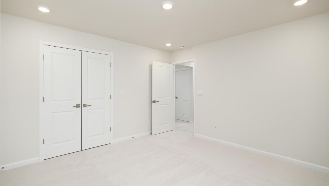 Carpeted bedroom with small window