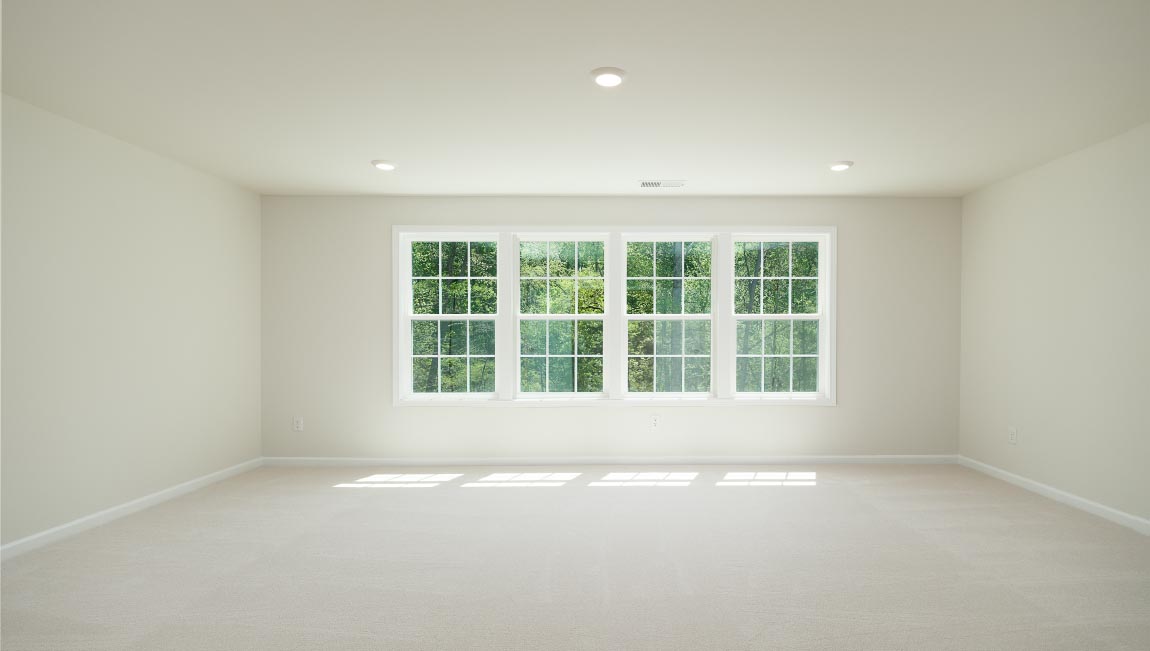 Carpeted bedroom with small window