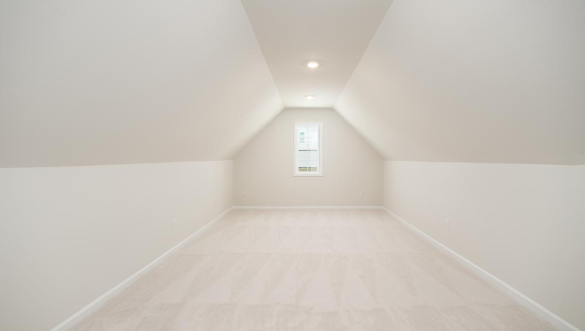 Carpeted bedroom with small window