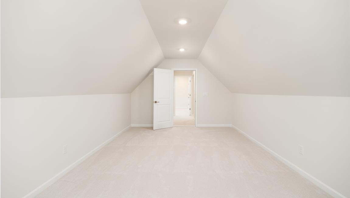 Carpeted bedroom with small window