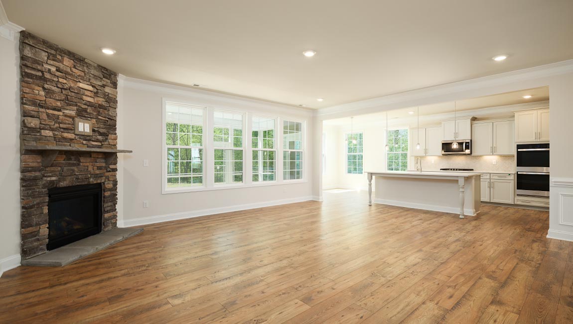 Open great room with large windows and fireplace