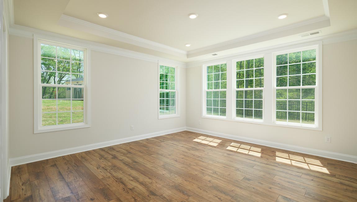 Open great room with large windows and fireplace