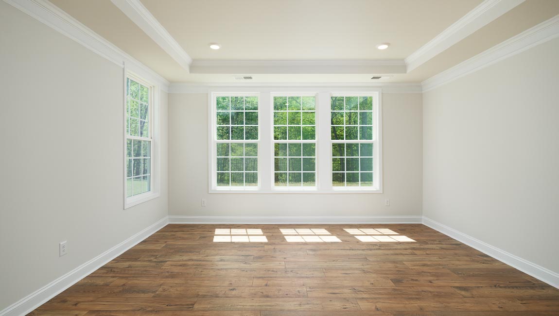 Open great room with large windows and fireplace