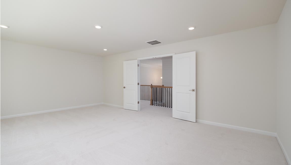 Carpeted bedroom with small window