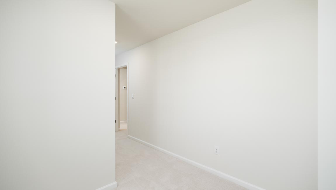 Carpeted bedroom with small window