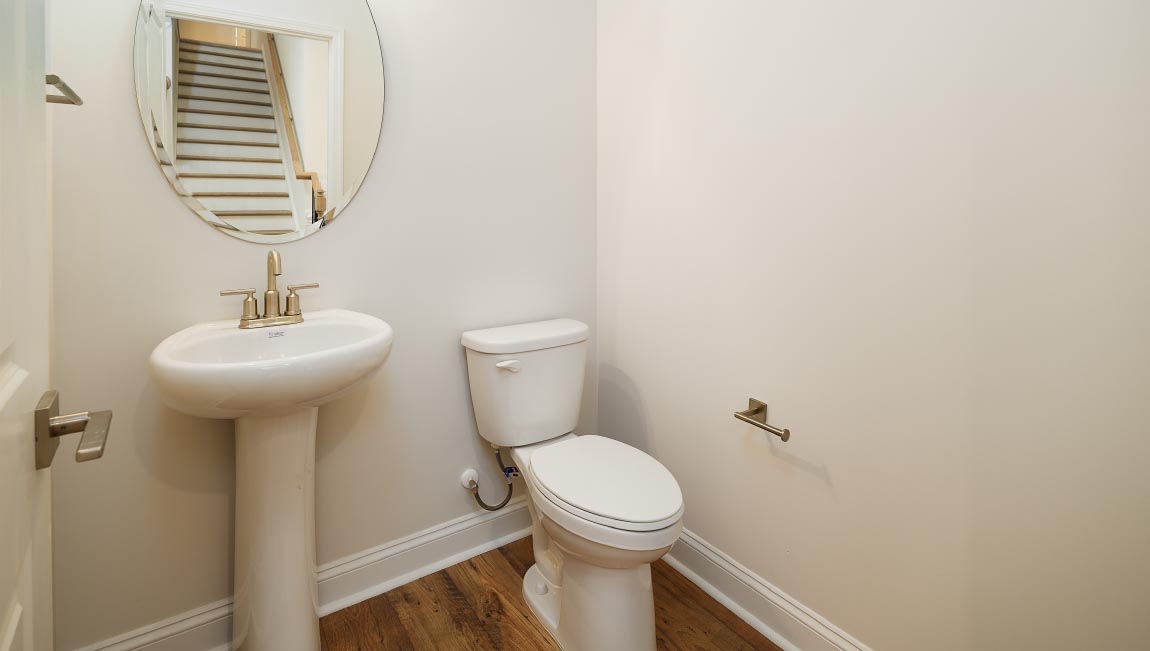 Powder bathroom with small sink and toilet