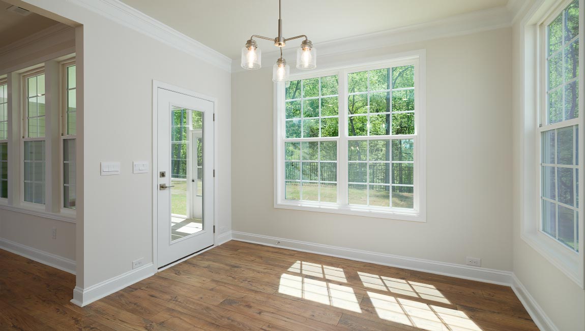 Dining room with large window, and chandelier
