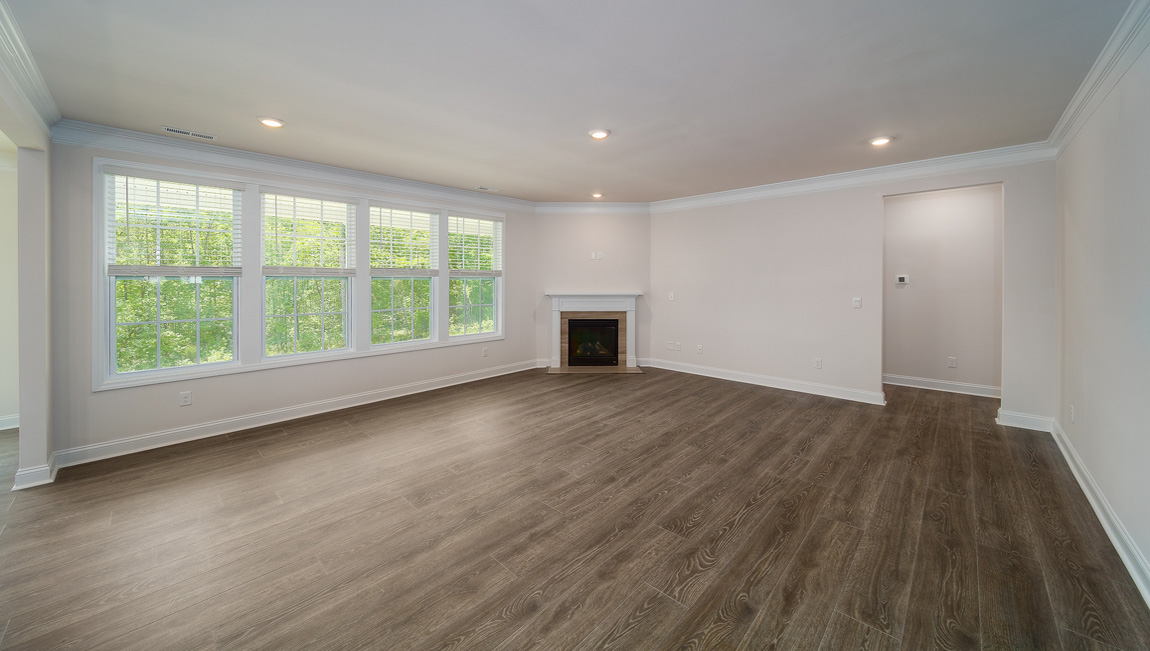 Open great room with large windows and fireplace