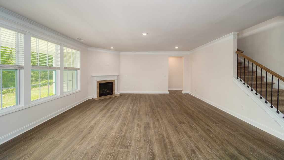 Open great room with large windows and fireplace