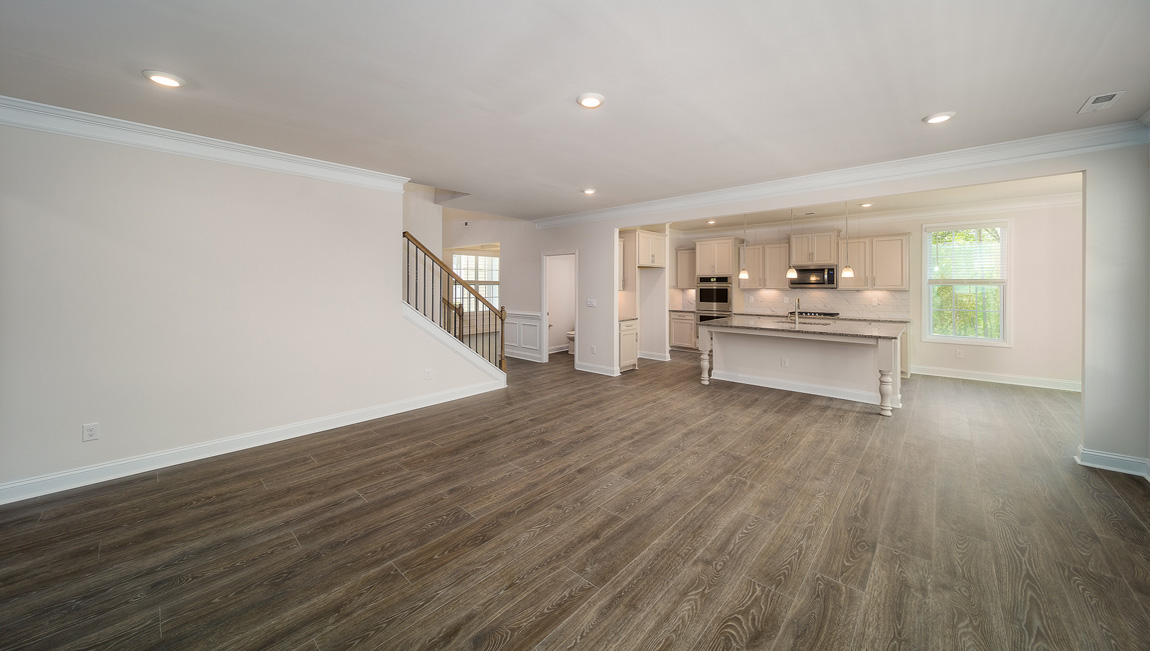 Open great room with large windows and fireplace