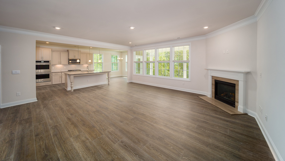 Open great room with large windows and fireplace