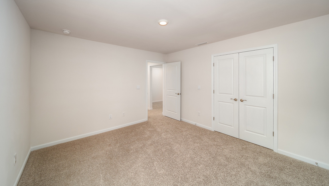 Carpeted bedroom, view of entryway