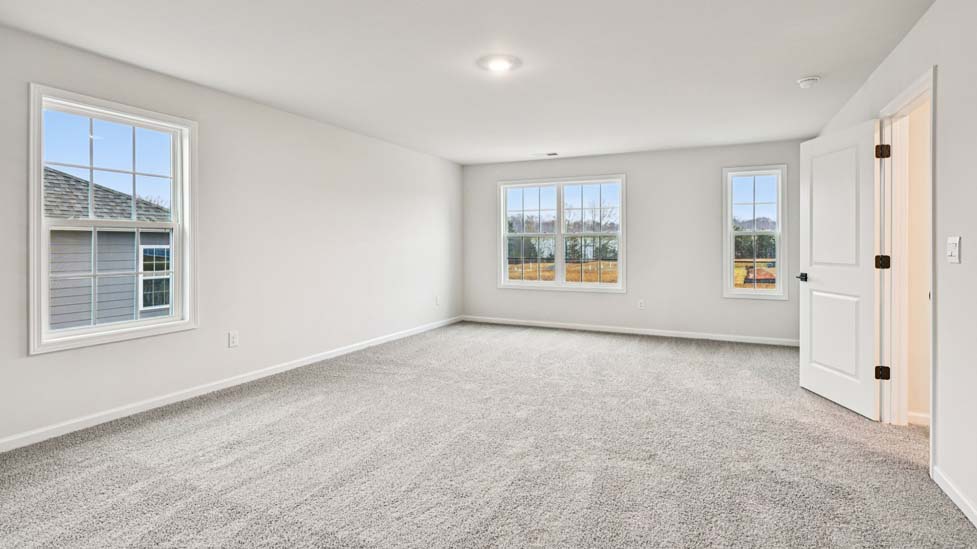 Carpeted bedroom with windows