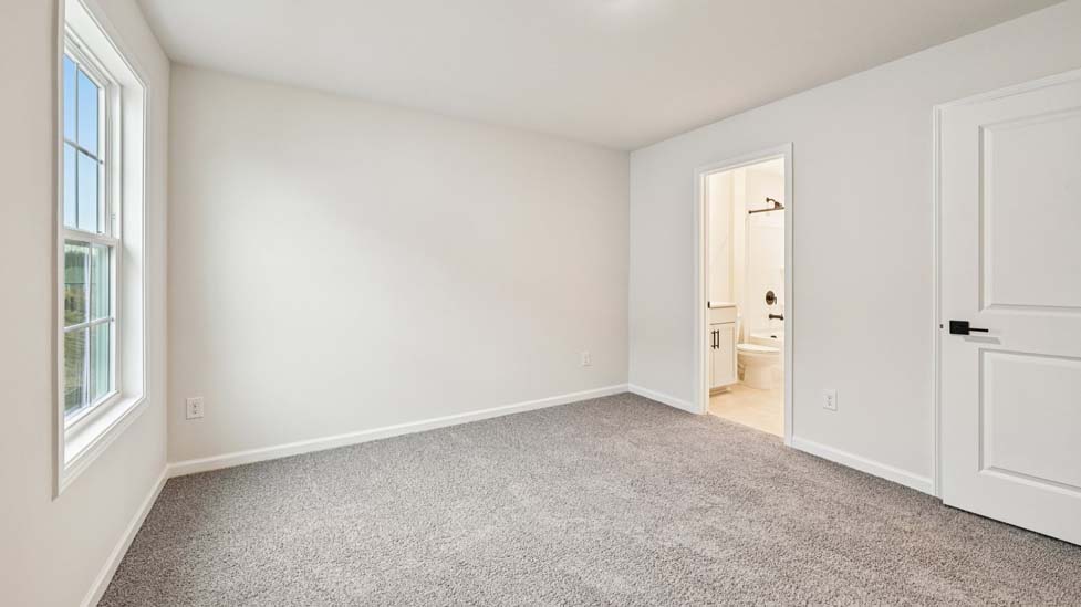 Carpeted bedroom with windows