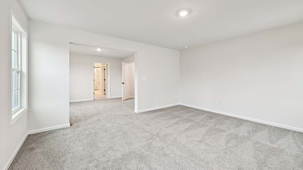 Primary bedroom, carpeted, with three windows