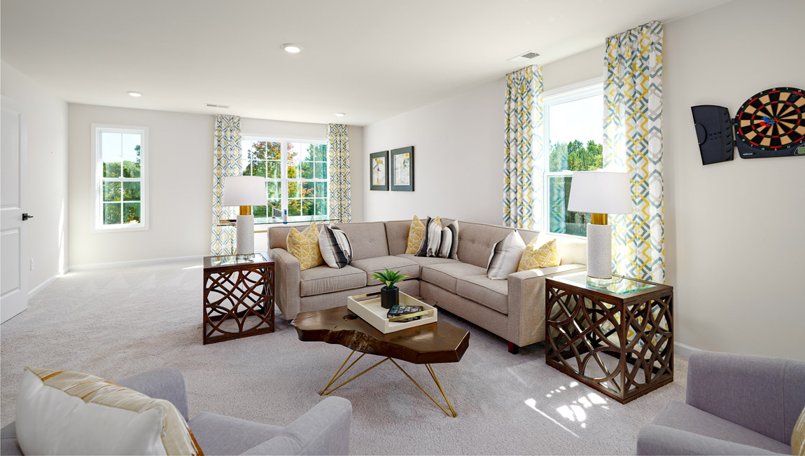Loft space with carpet and two large windows