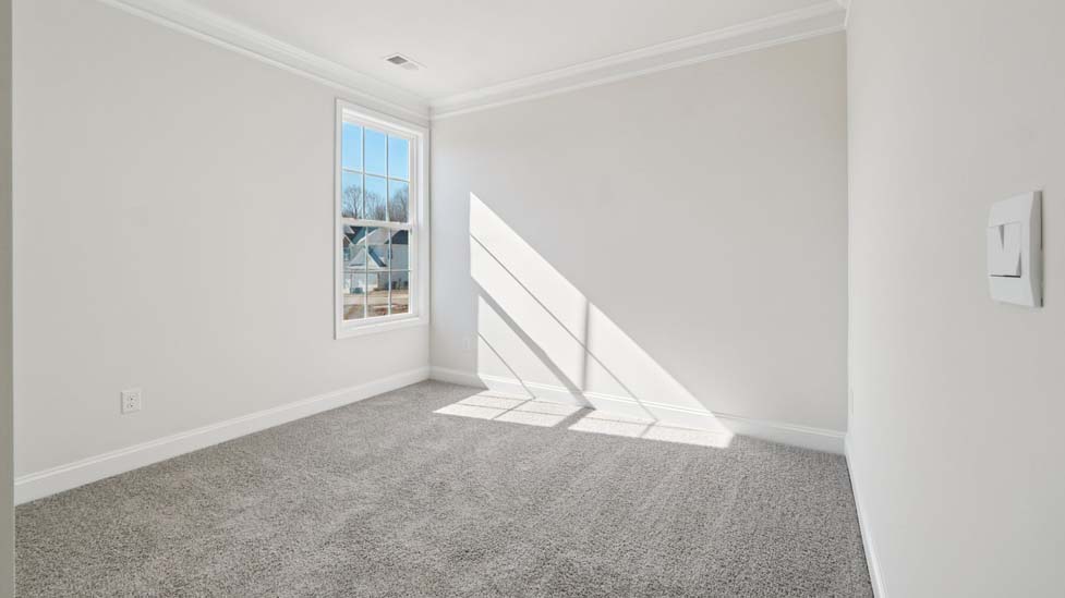 Carpeted bedroom with large window