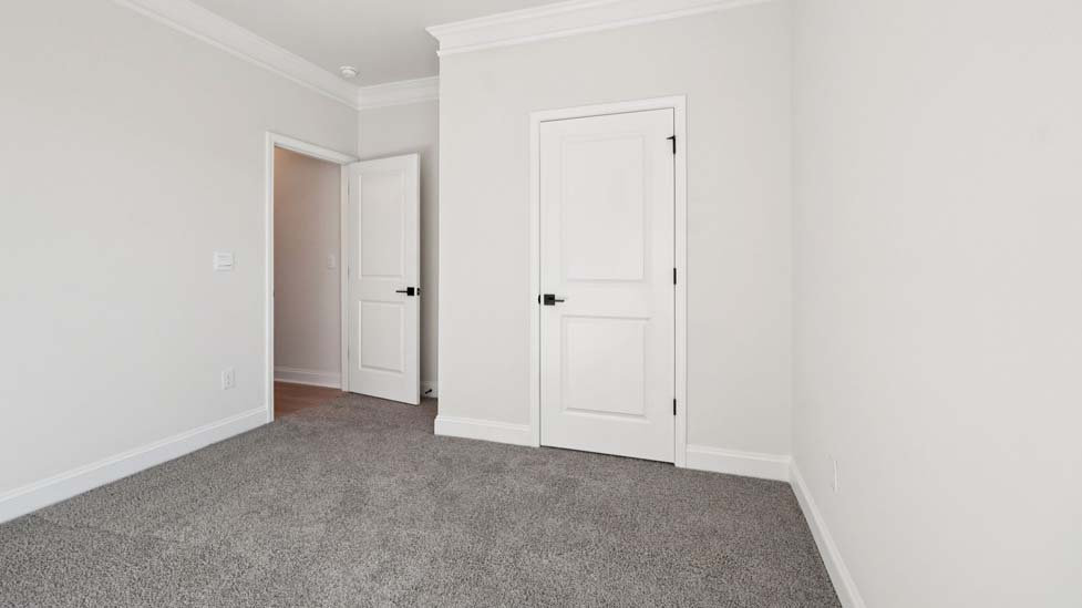 Carpeted bedroom with large window