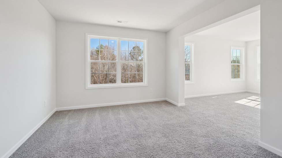 Carpeted bedroom with large window