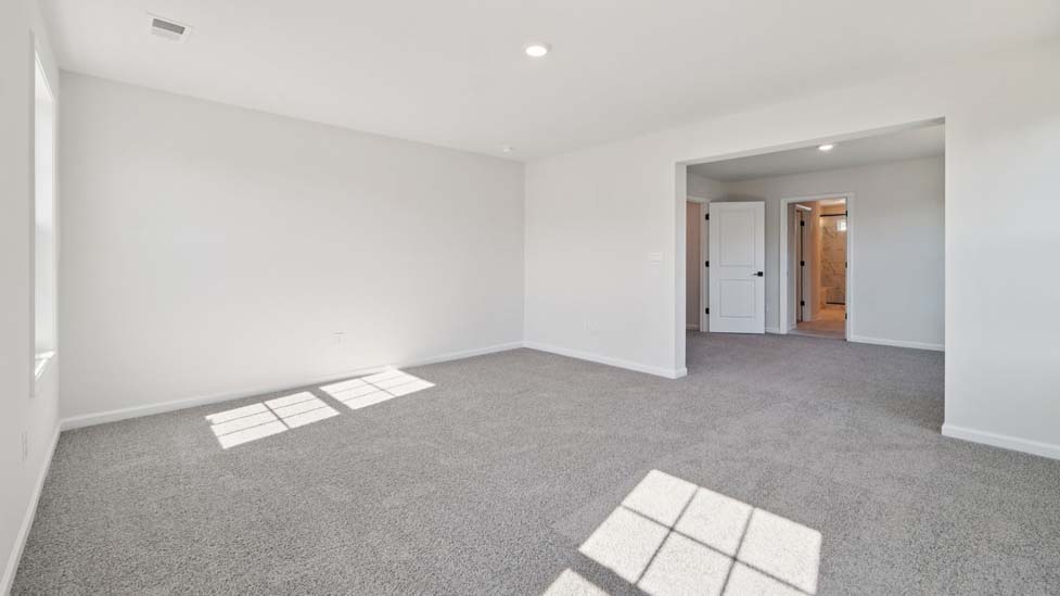 Carpeted bedroom with large window
