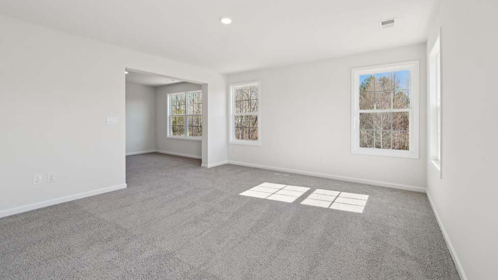 Carpeted bedroom with large window