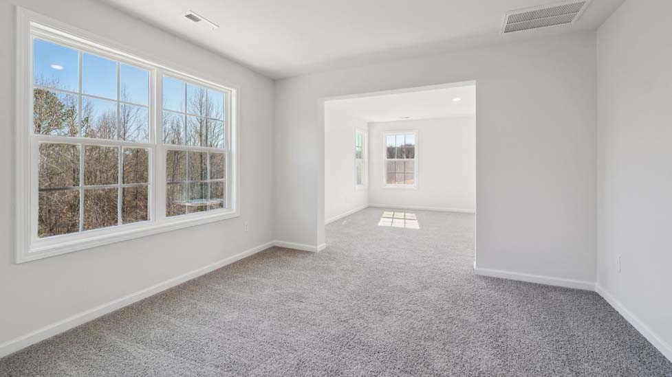 Carpeted bedroom with large window