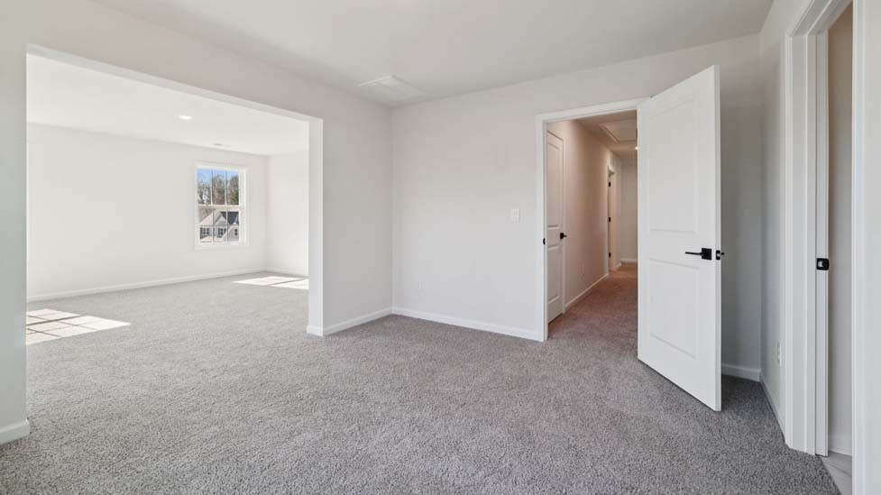 Carpeted bedroom with large window