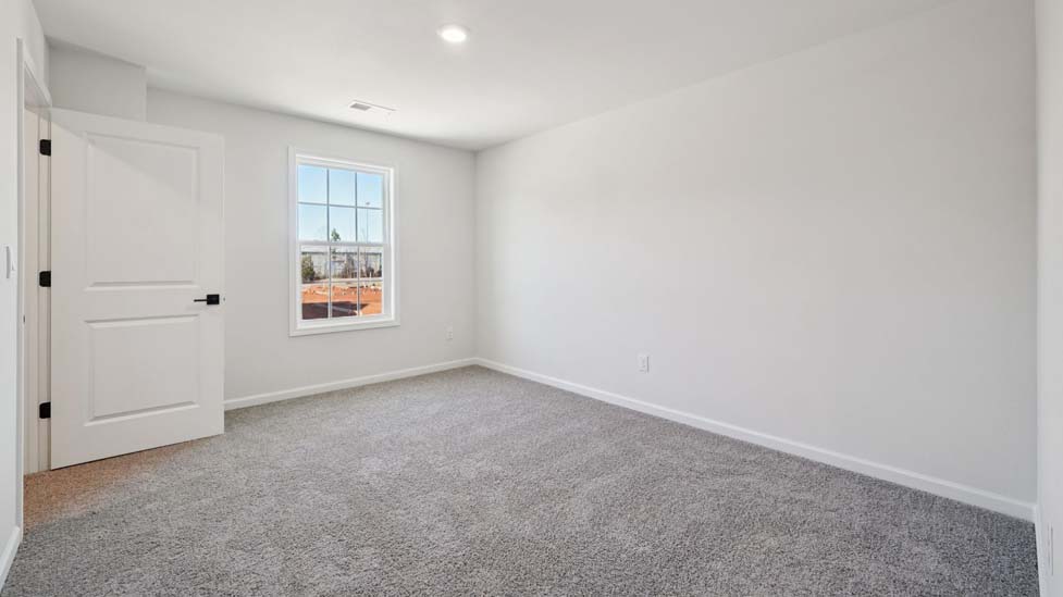 Carpeted bedroom with large window