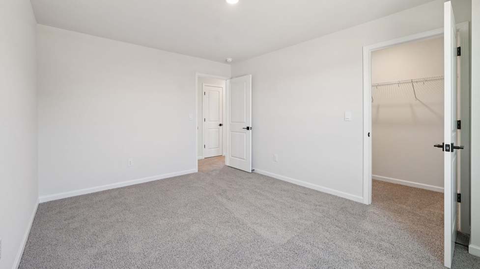 Carpeted bedroom with large window