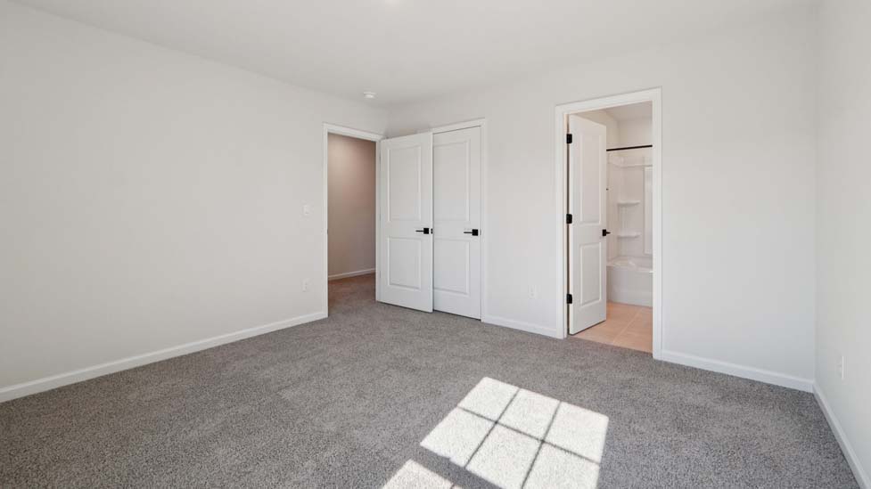 Carpeted bedroom with large window
