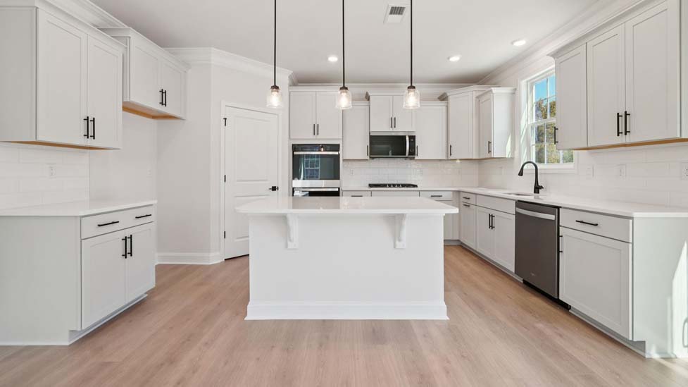 Kitchen and island with stainless steel appliances