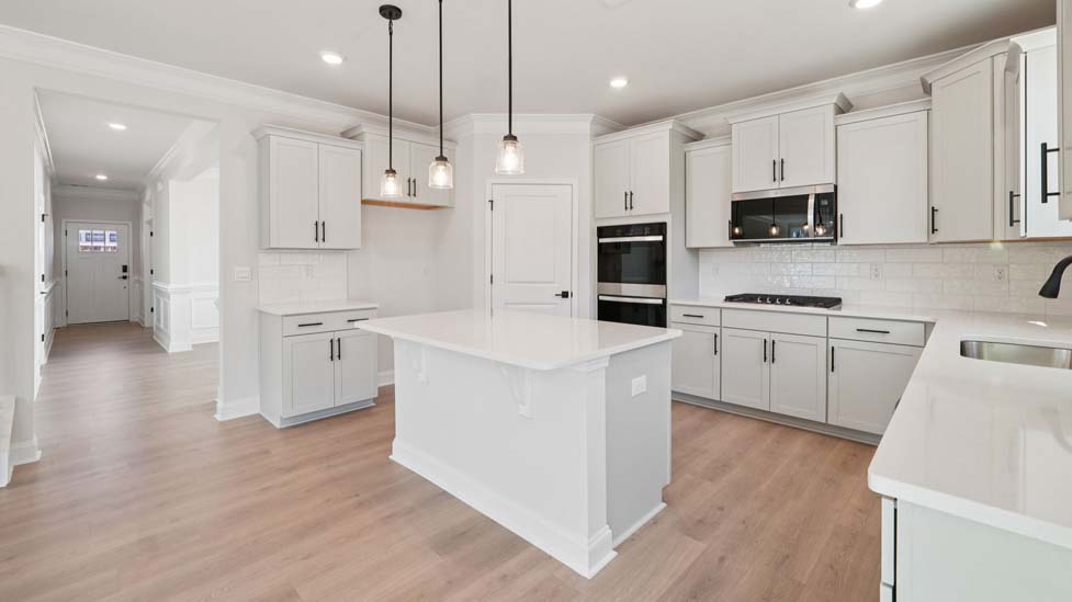 Kitchen and island with stainless steel appliances