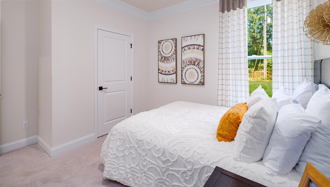 Carpeted bedroom with windows