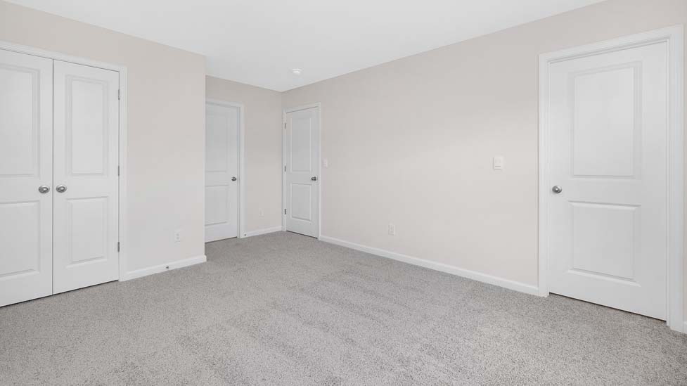 Carpeted bedroom with windows