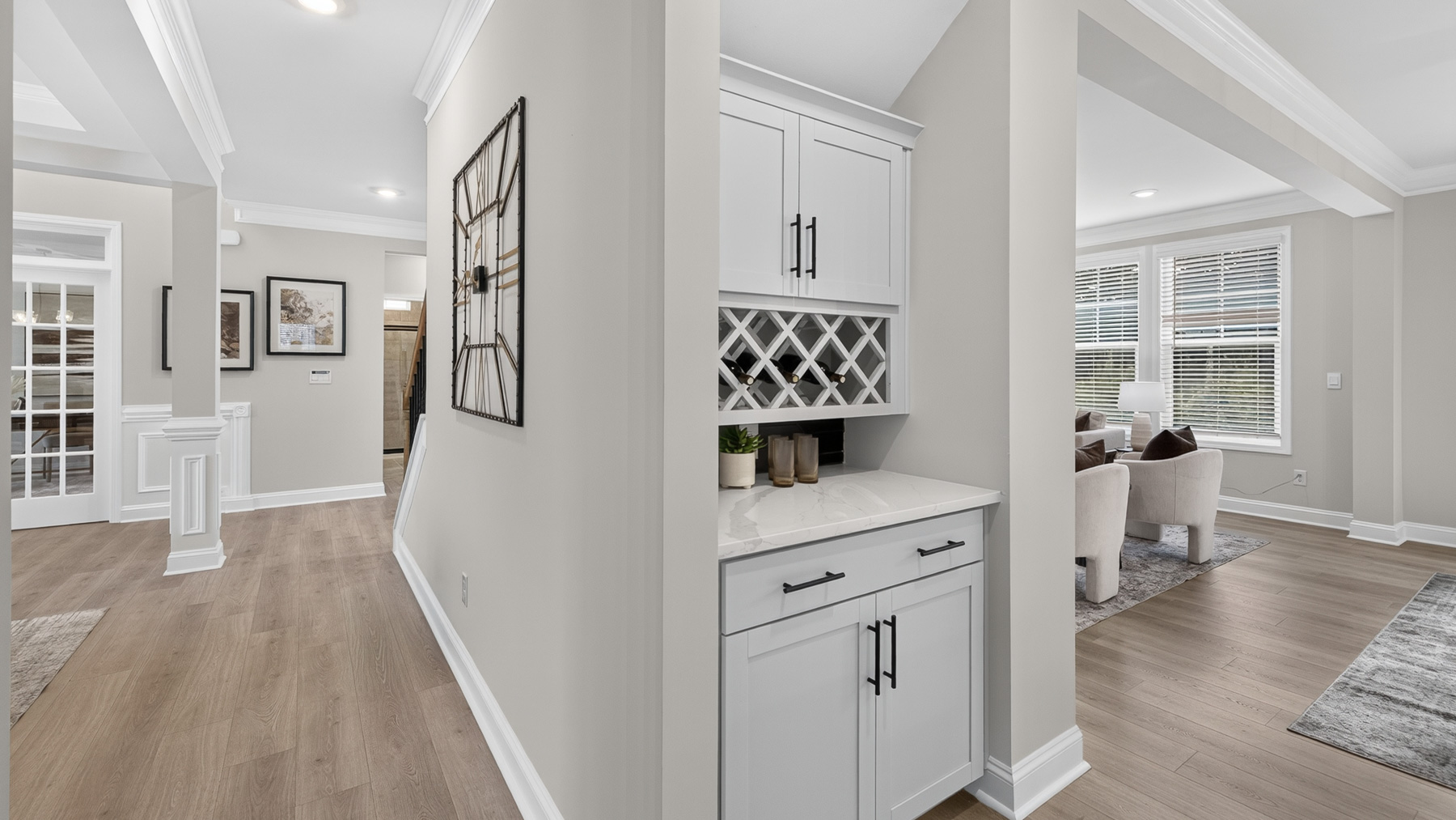 Kitchen and island with white cabinets and stainless steel appliances