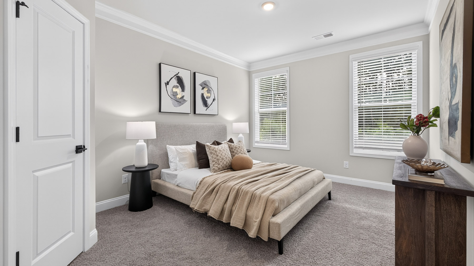 Carpeted bedroom with windows