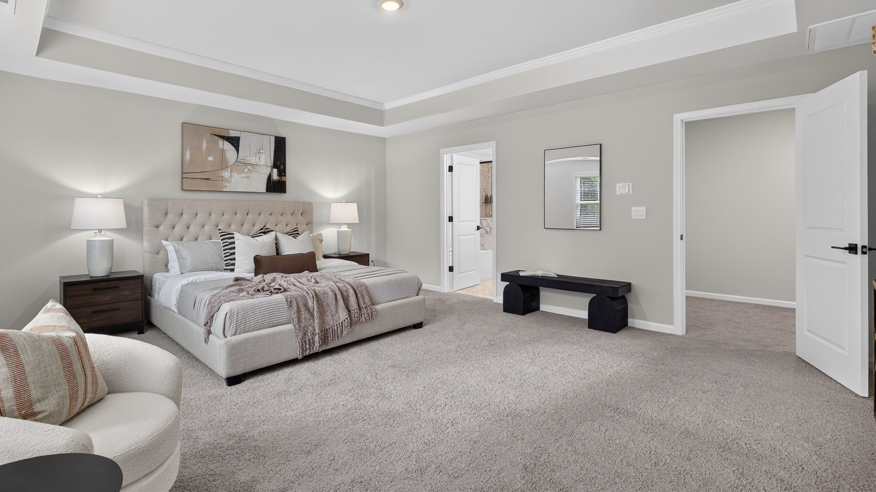 Primary bedroom with carpet, large windows, and seating area
