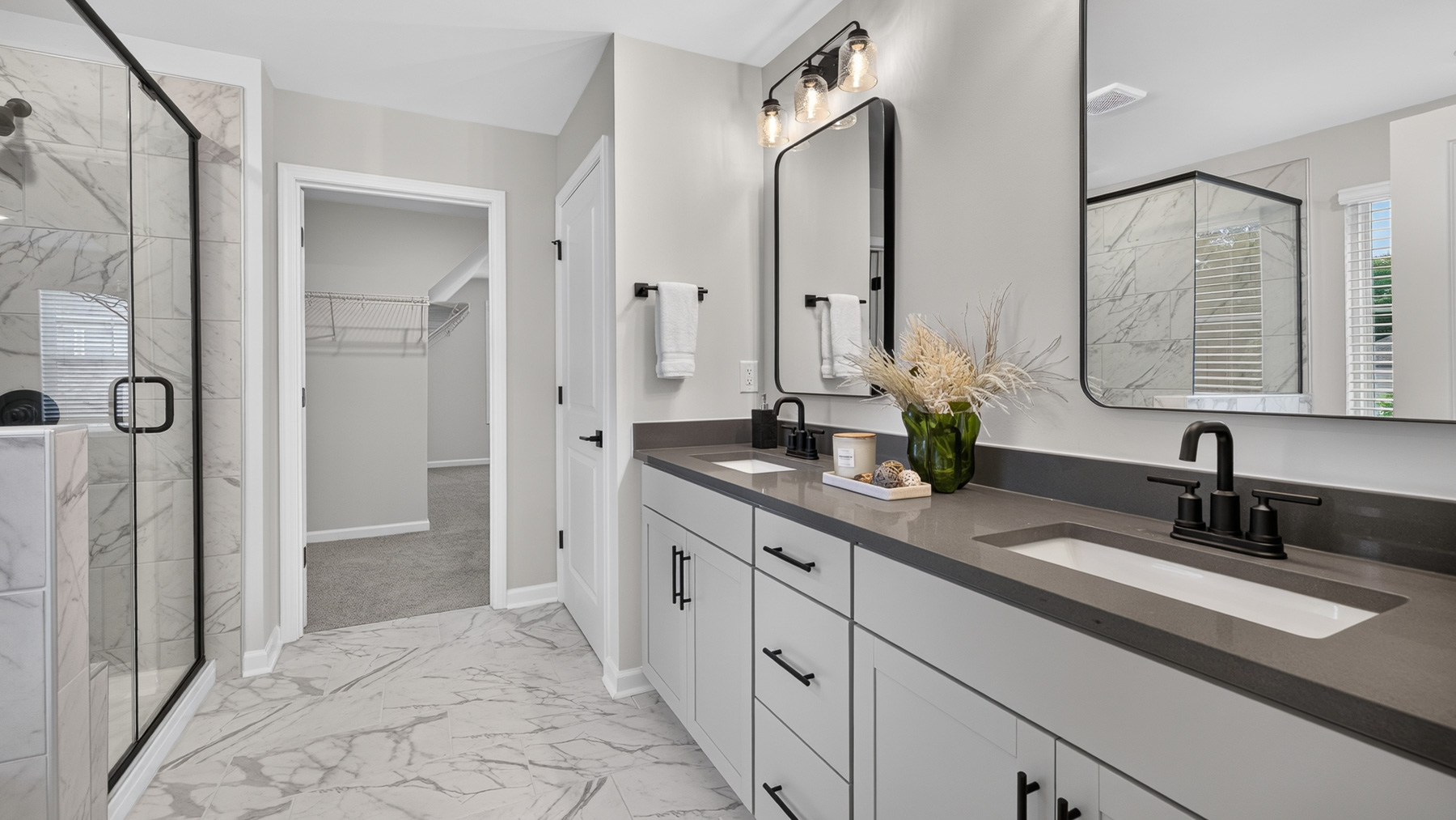 Primary bathroom with white cabinets, large bathtub ad shower