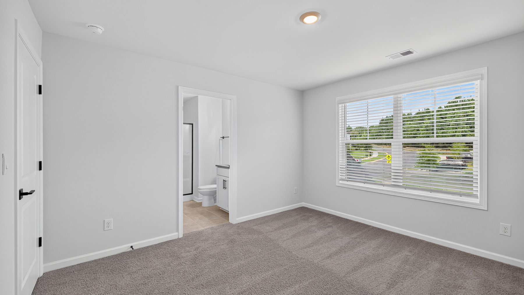 Carpeted bedroom with windows