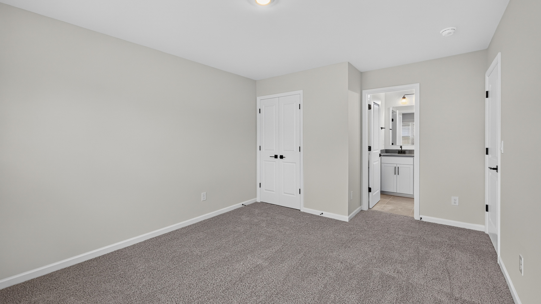 Carpeted bedroom with windows